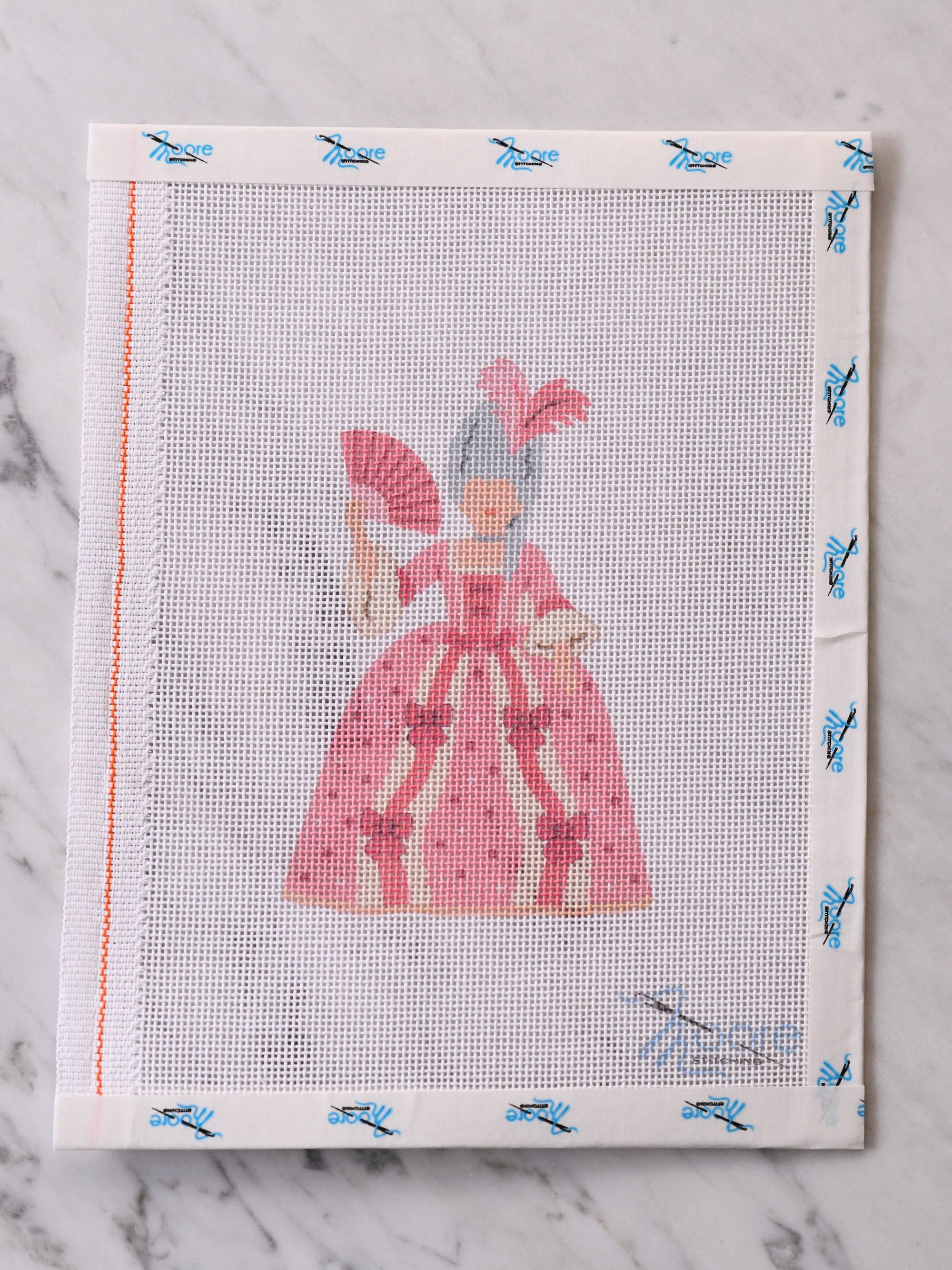 Cross-stitched queen in a pink dress on a white mesh fabric.