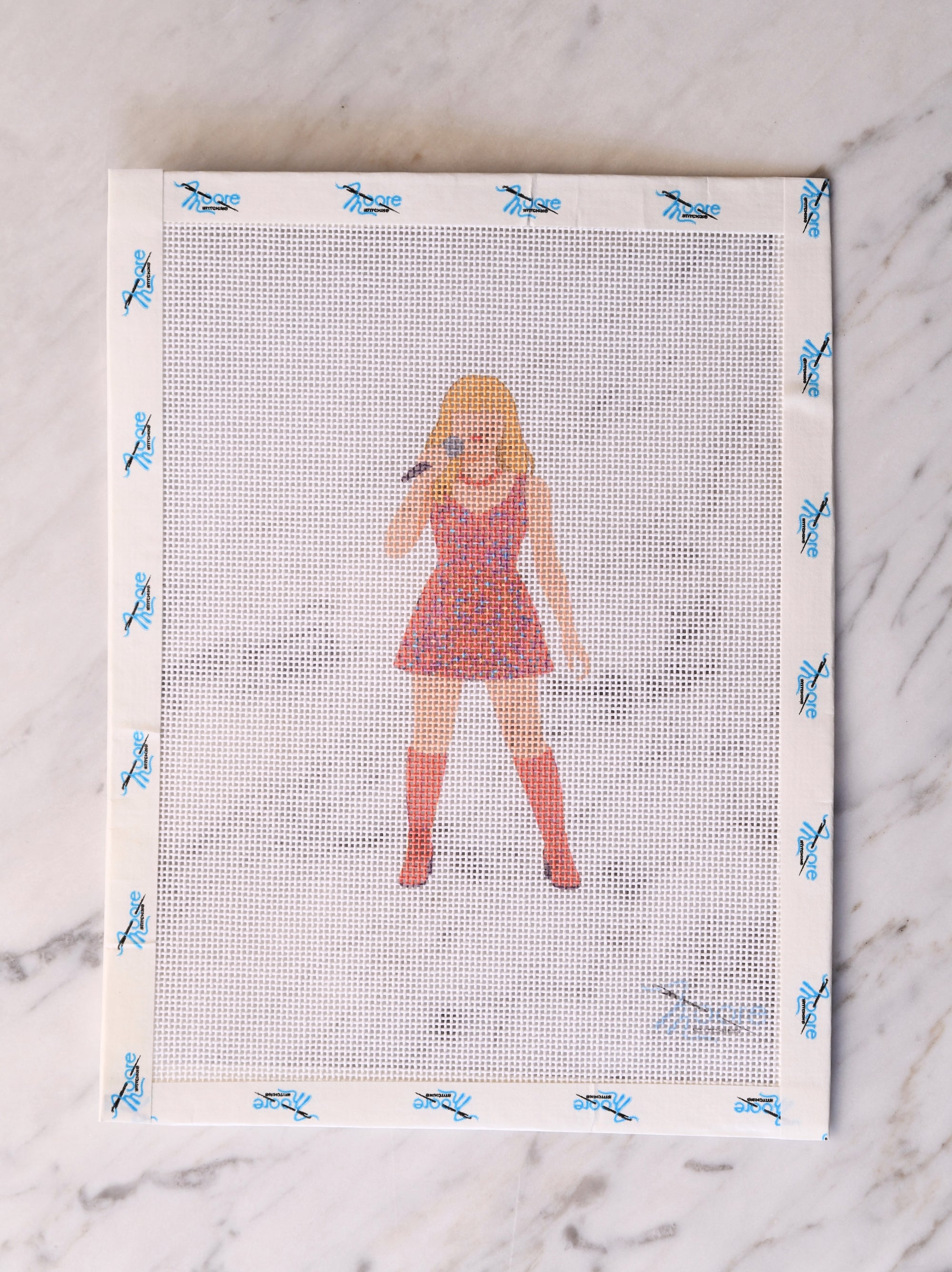 Screen printing frame with a design of a singer in a dress and knee-high boots.