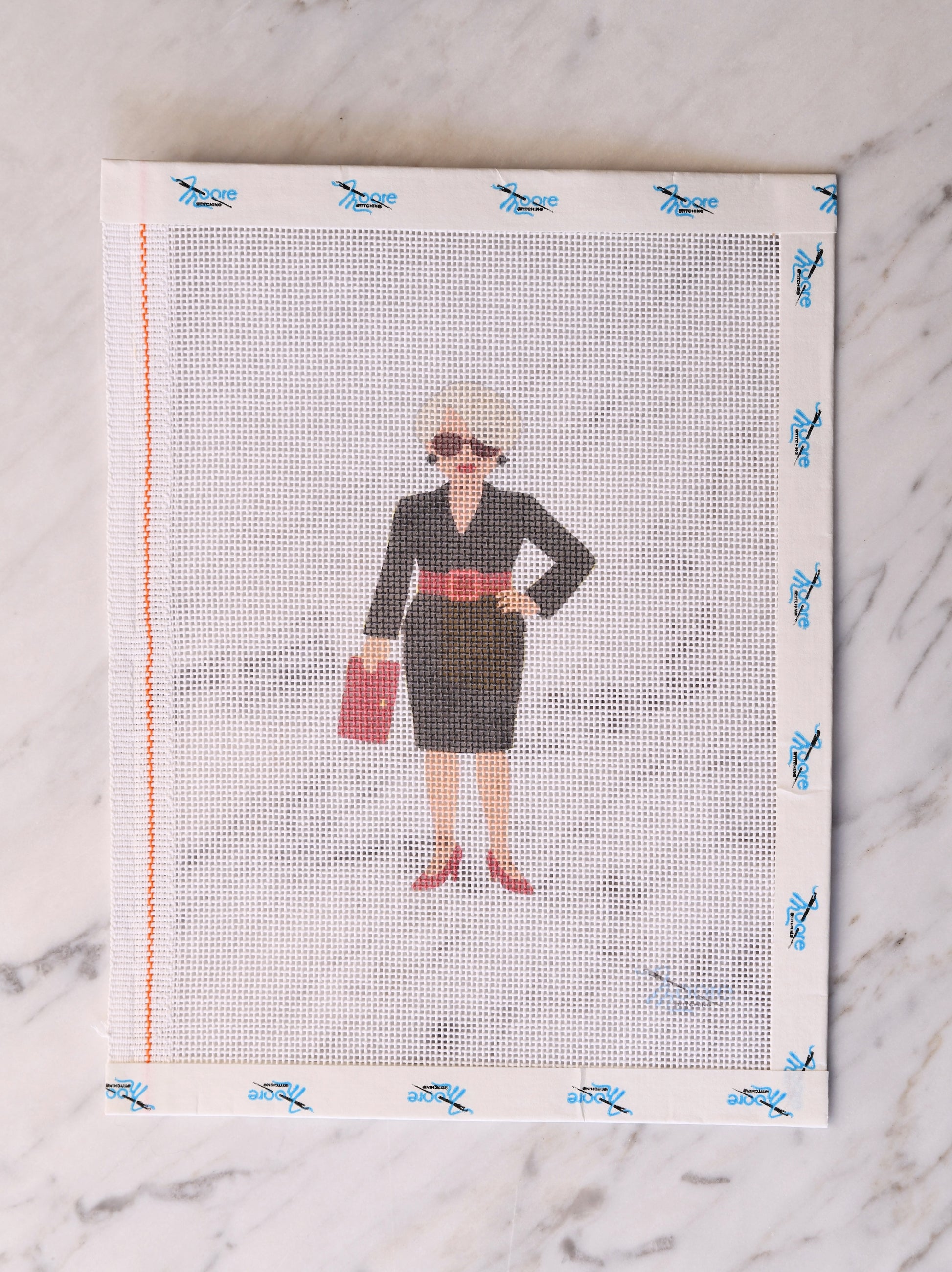 Screen printing screen with a design of a woman in a black dress on a marble surface