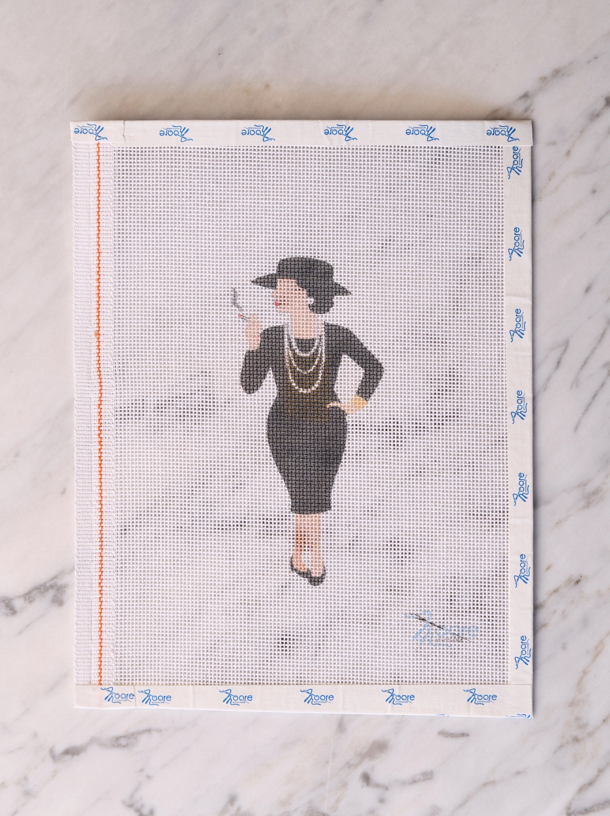 Cross-stitch pattern with a woman's silhouette on a white background.
